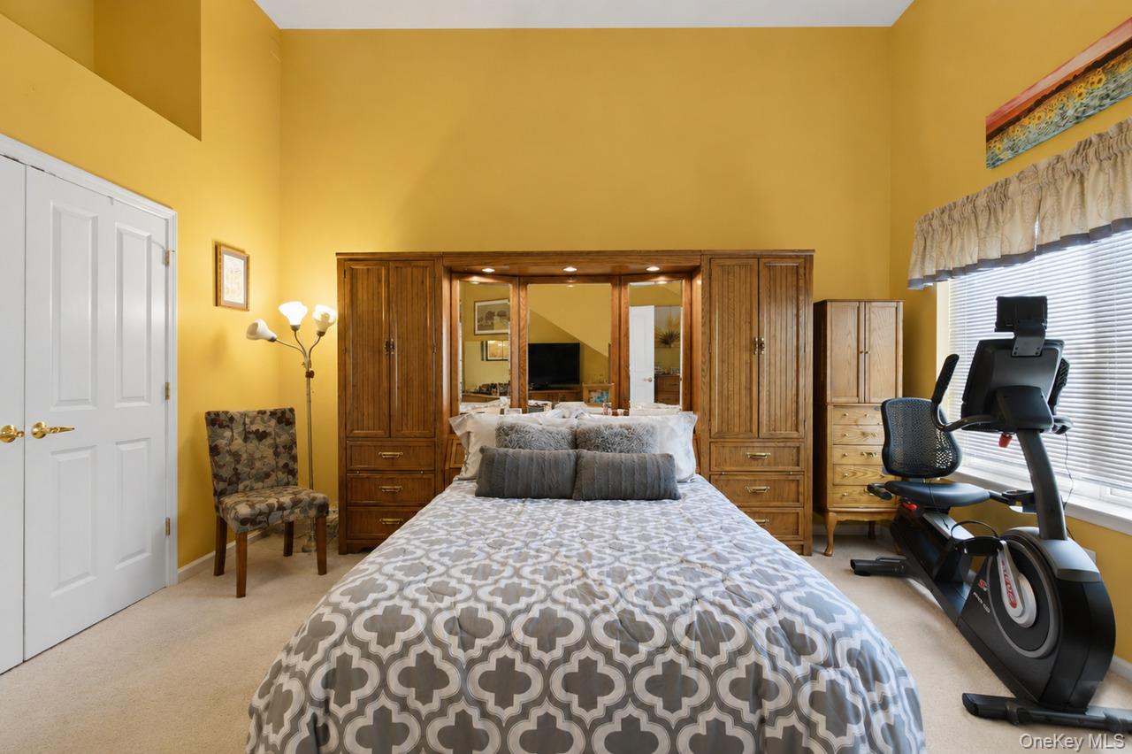 64 Roma Orchard Road Peekskill, NY 10566 - Photo 24 of 40 Spacious room featuring vaulted ceilings, light-toned carpeting, a large window with blinds, and white bi-fold closet doors