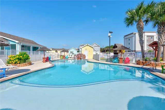 a view of a swimming pool with outdoor seating