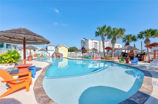 an outdoor space with swimming pool and furniture