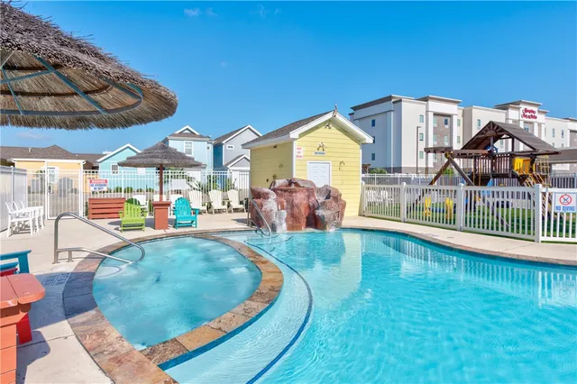 an aerial view of a house with swimming pool patio and outdoor seating
