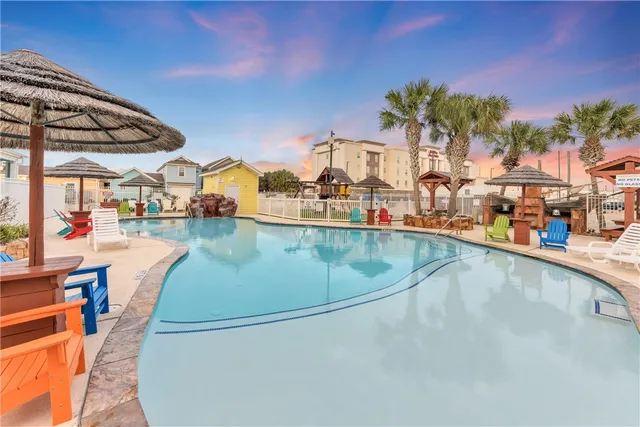 an outdoor space with swimming pool and furniture