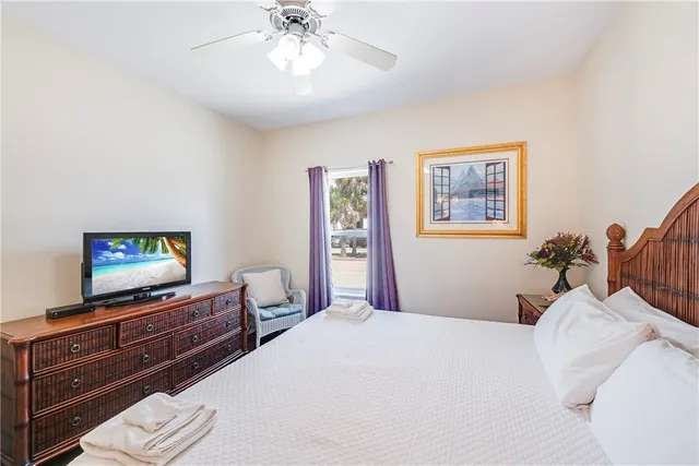 a front view of a house with palm trees