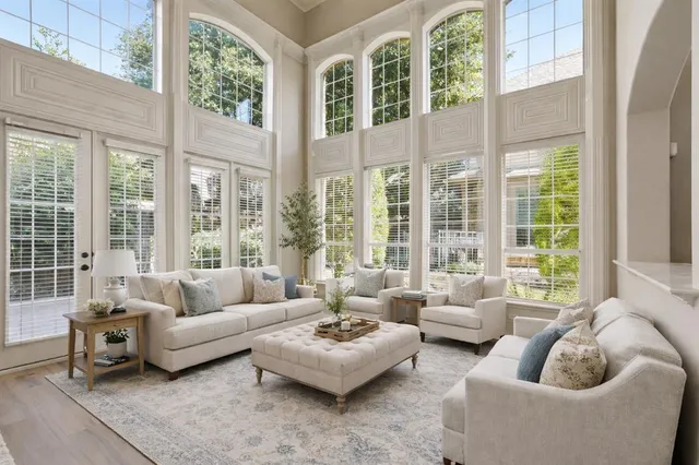 a view of a livingroom with wooden floor and a ceiling fan