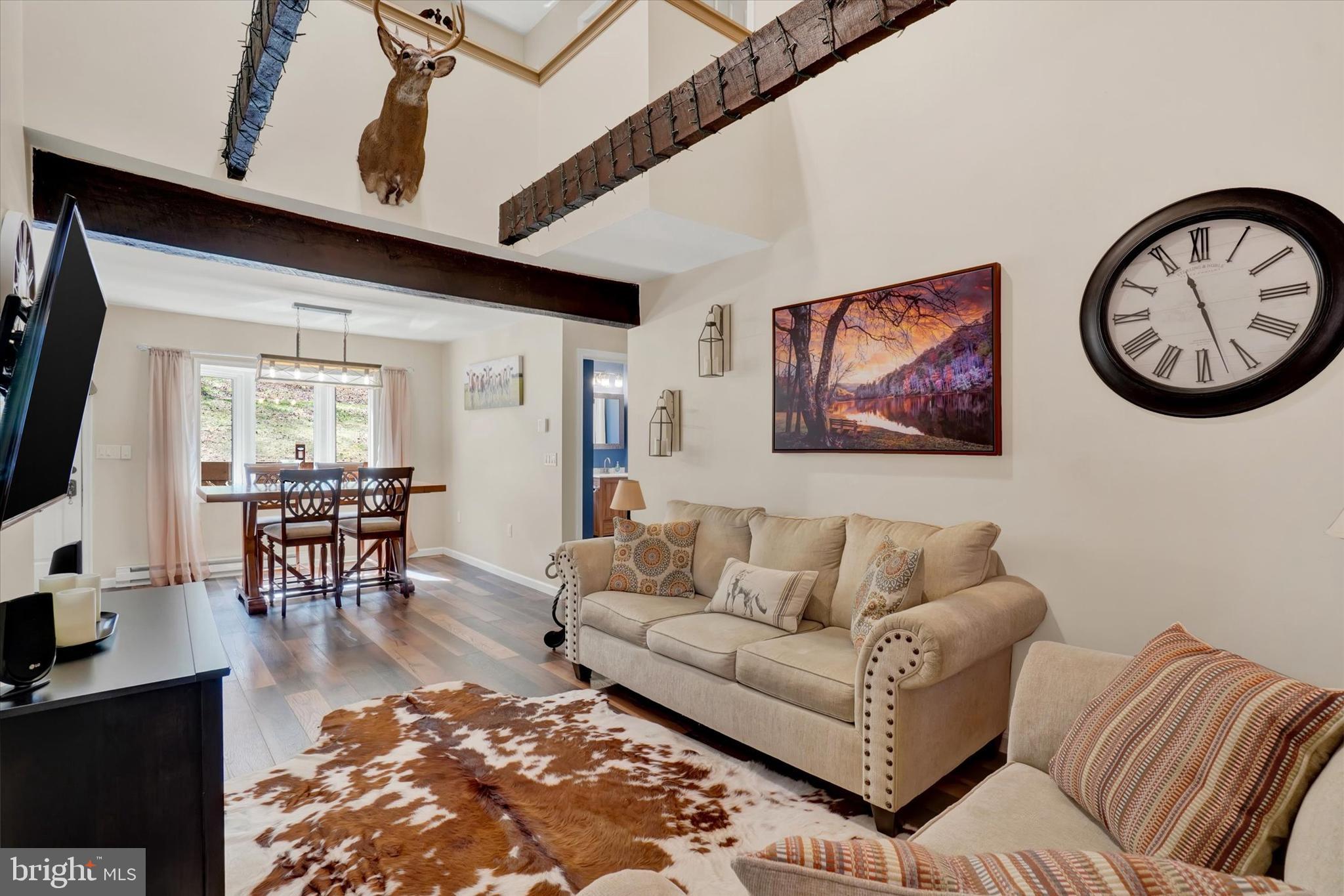 82 Fox Creek Road Wrightsville, PA 17368 - Photo 14 of 32 a living room with furniture a wooden floor and a chandelier