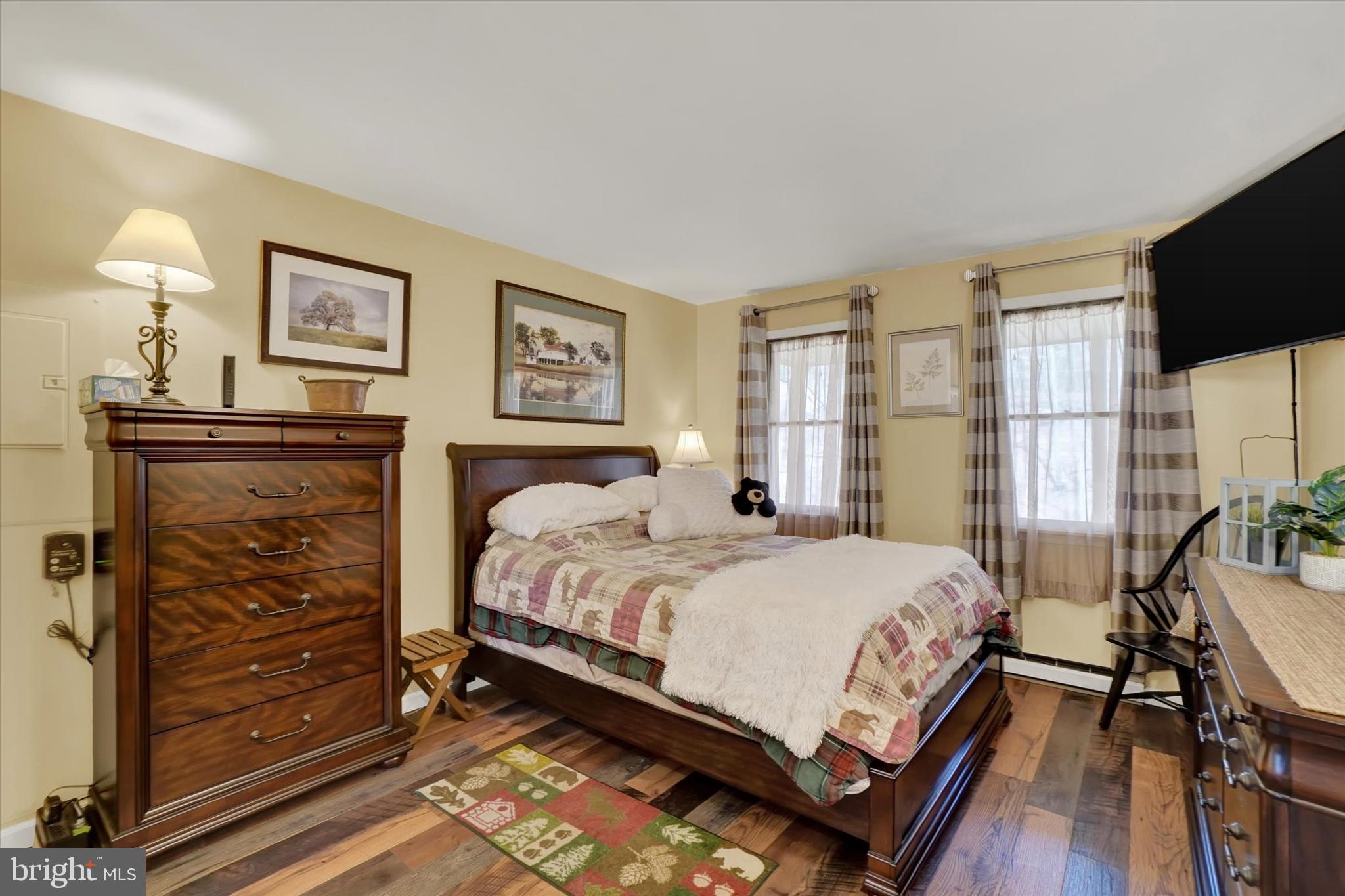 82 Fox Creek Road Wrightsville, PA 17368 - Photo 9 of 32 a bedroom with a bed next to a window with a flat screen tv