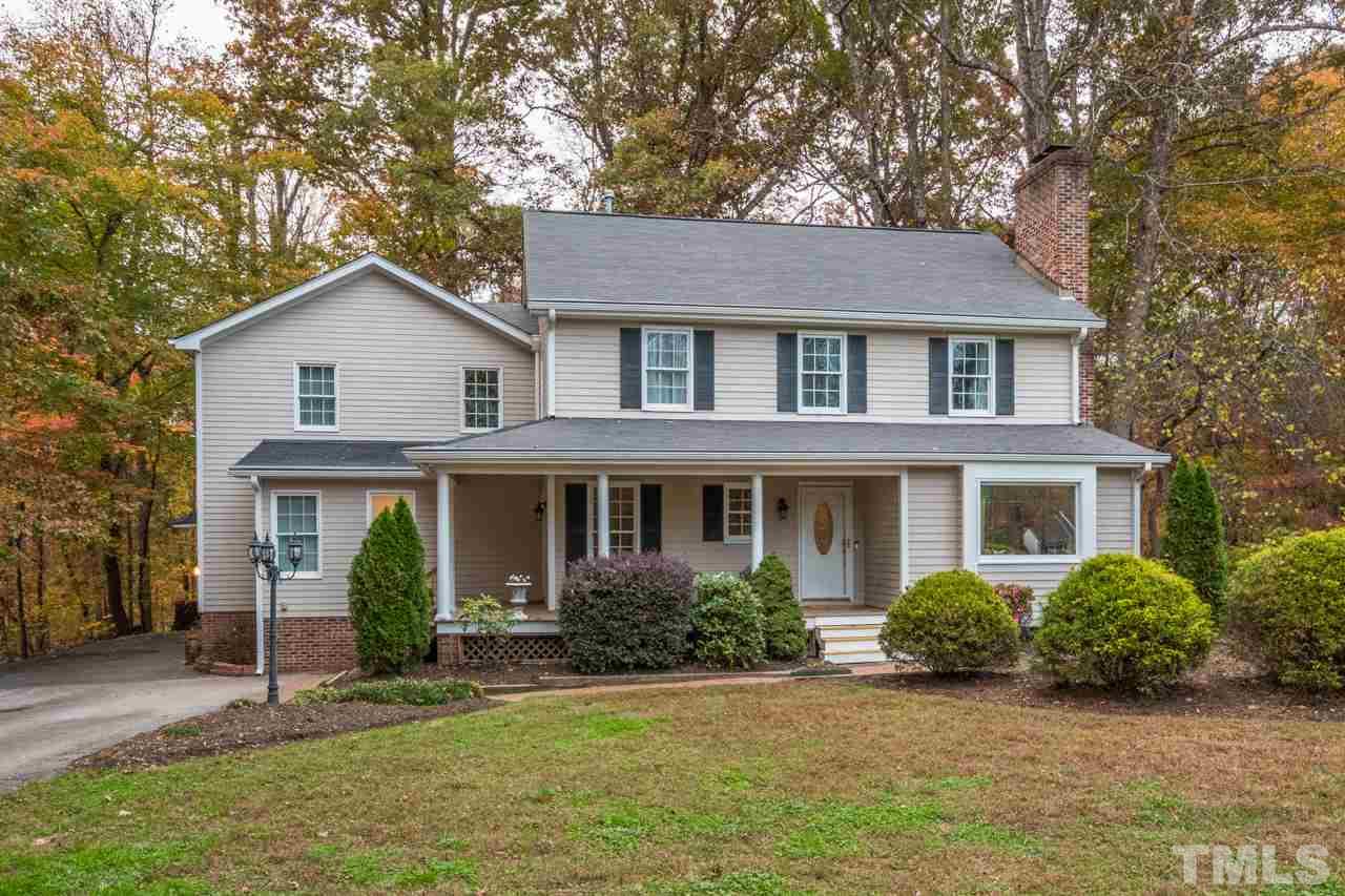 12217 Norwood Road Raleigh, NC 27613 - Photo 1 of 27 a front view of a house with a garden and yard