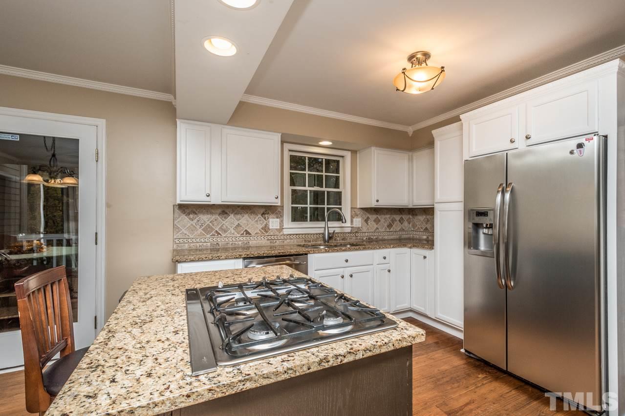 12217 Norwood Road Raleigh, NC 27613 - Photo 11 of 27 a kitchen with stainless steel appliances granite countertop a sink stove and refrigerator