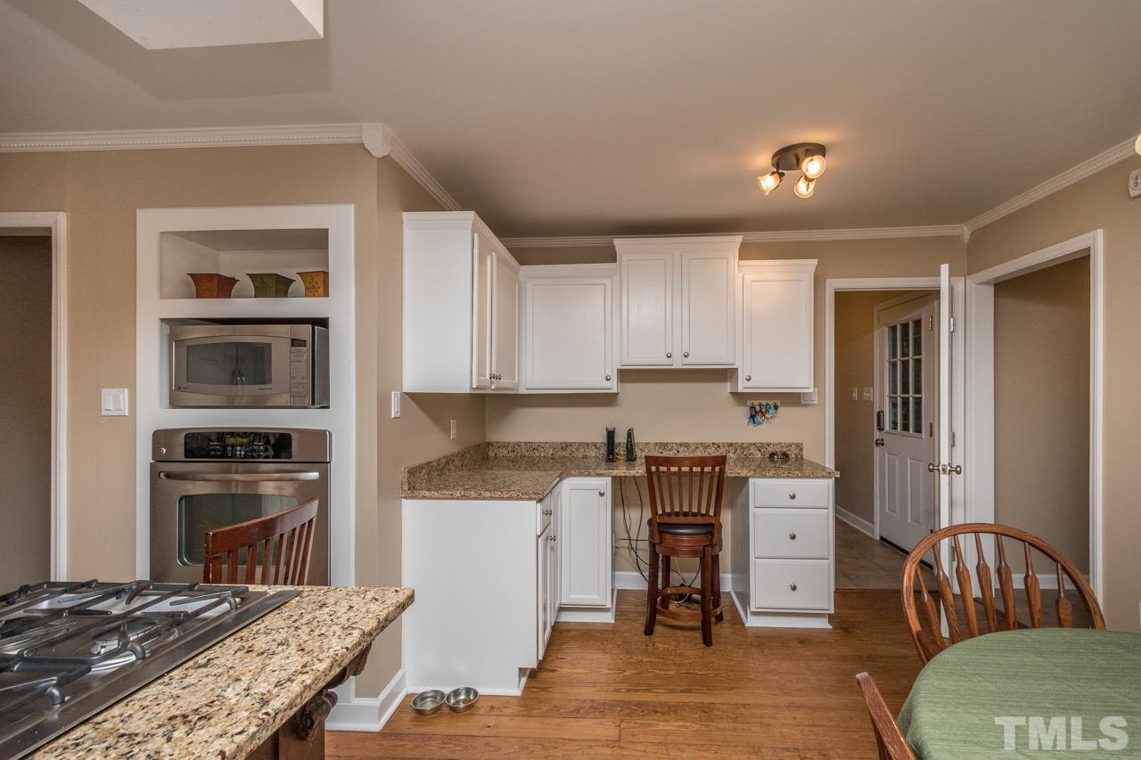 12217 Norwood Road Raleigh, NC 27613 - Photo 13 of 27 a kitchen with stainless steel appliances granite countertop a refrigerator stove top oven and sink