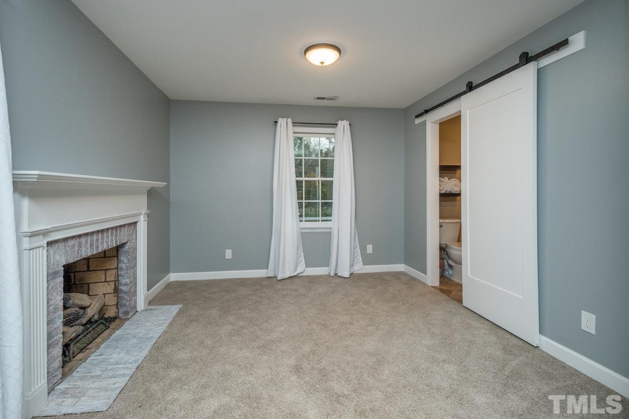 12217 Norwood Road Raleigh, NC 27613 - Photo 17 of 27 a view of an empty room with window and fire place