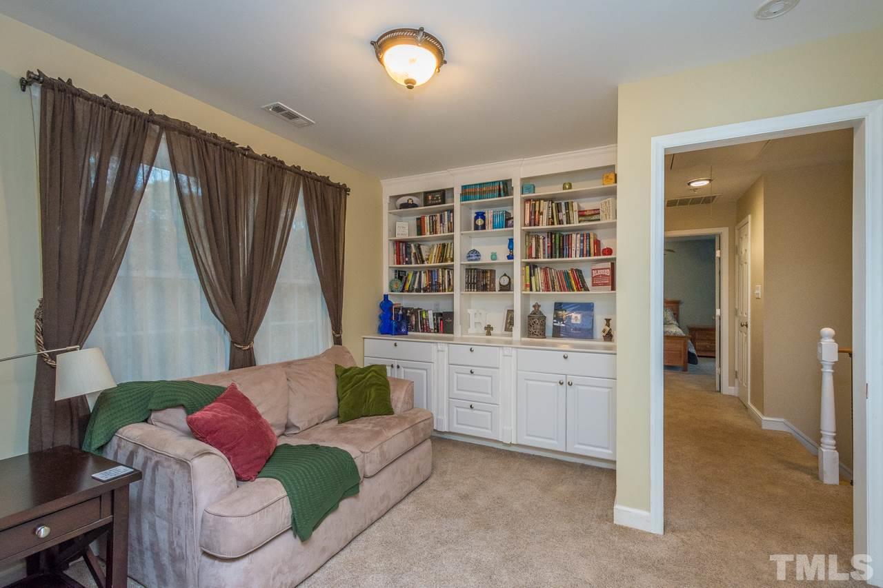 12217 Norwood Road Raleigh, NC 27613 - Photo 21 of 27 a living room with furniture and a wooden floor