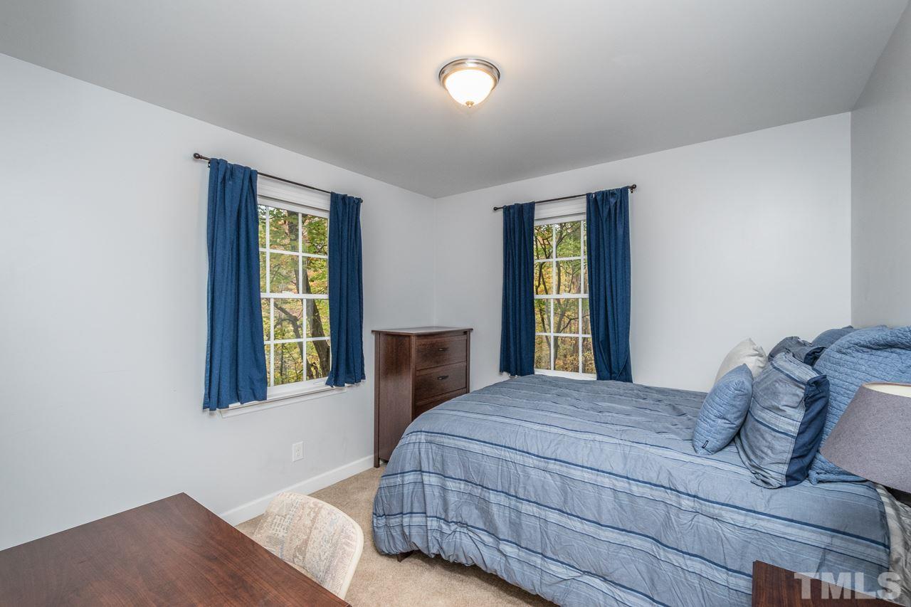 12217 Norwood Road Raleigh, NC 27613 - Photo 25 of 27 a bedroom with a bed and a window