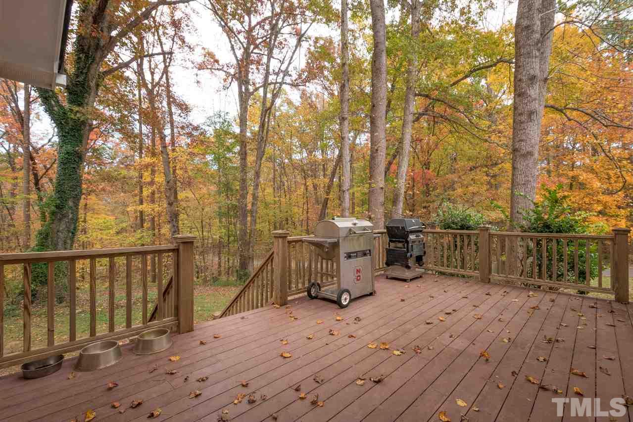 12217 Norwood Road Raleigh, NC 27613 - Photo 6 of 27 a view of a wooden deck and a backyard