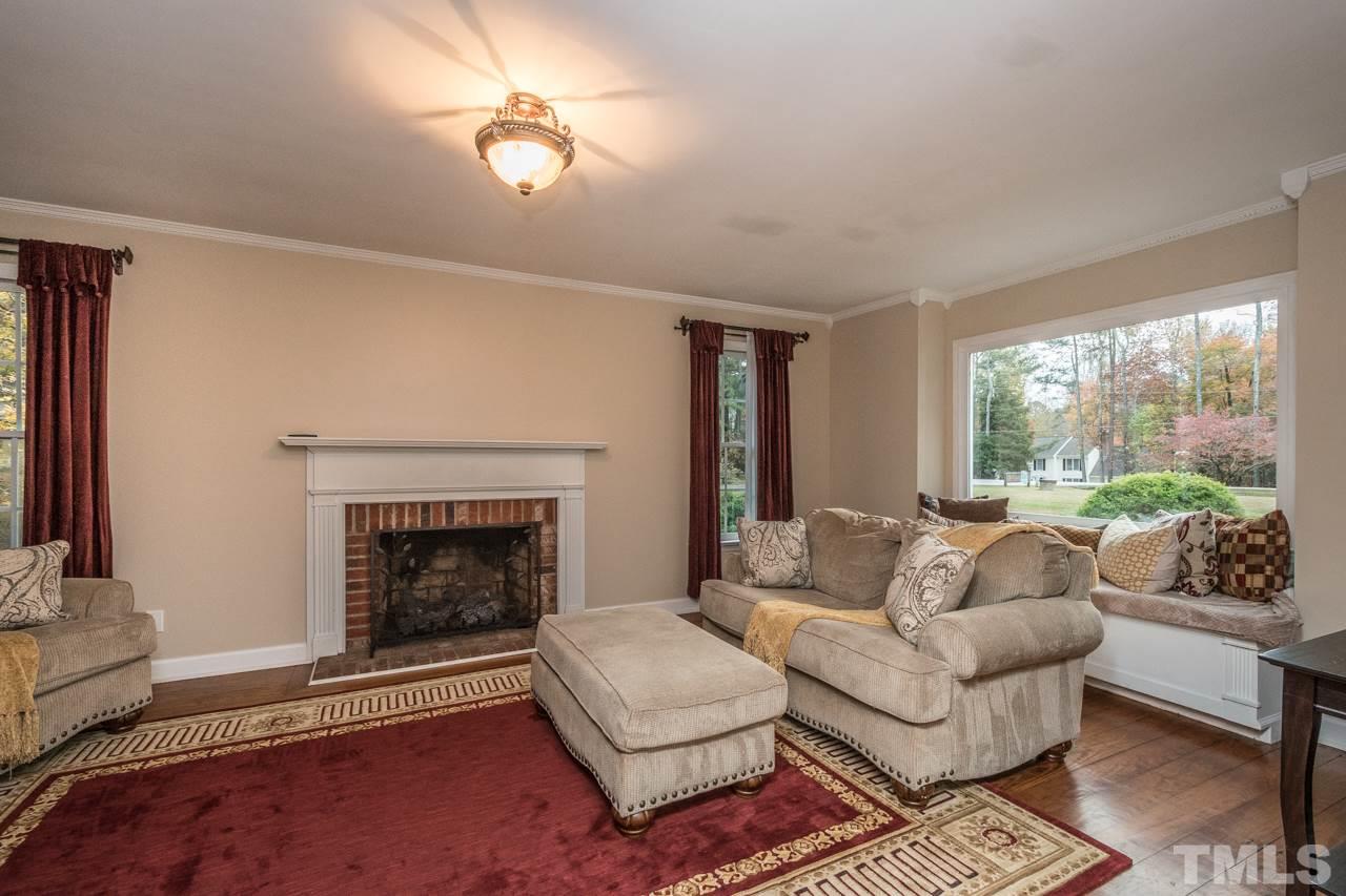 12217 Norwood Road Raleigh, NC 27613 - Photo 9 of 27 a living room with furniture and a fireplace