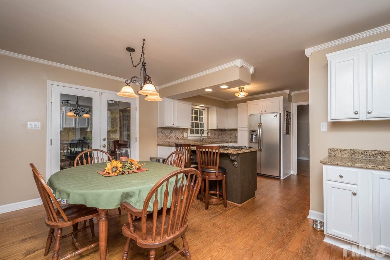 12217 Norwood Road Raleigh, NC 27613 - Photo 10 of 27 a view of a dining room with furniture and wooden floor