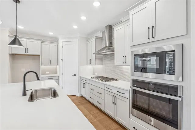 a kitchen with stainless steel appliances granite countertop a stove and a sink
