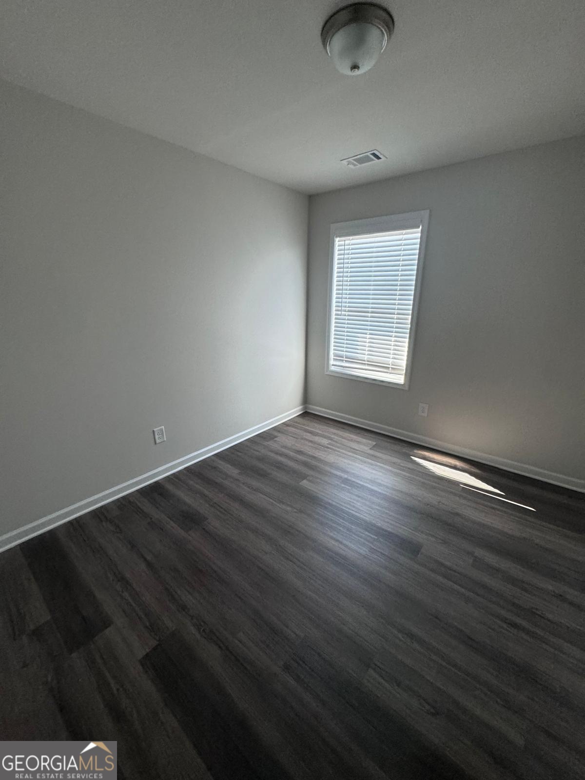 855 Pensive Run Dacula, GA 30019 - Photo 7 of 8 an empty room with wooden floor and windows