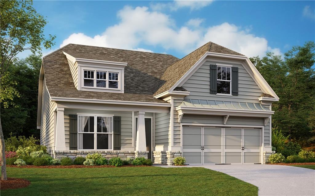 View of front of house featuring a front lawn and a garage