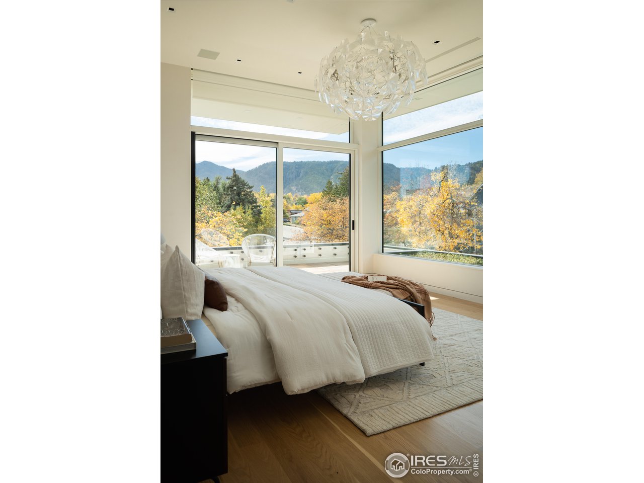 2670 6th Street Boulder, CO 80304 - Photo 16 of 37 a bedroom with a bed and a chandelier