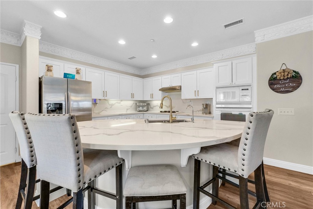 11499 Bridgeway Drive Riverside, CA 92505 - Photo 19 of 70 a kitchen with a dining table chairs and refrigerator