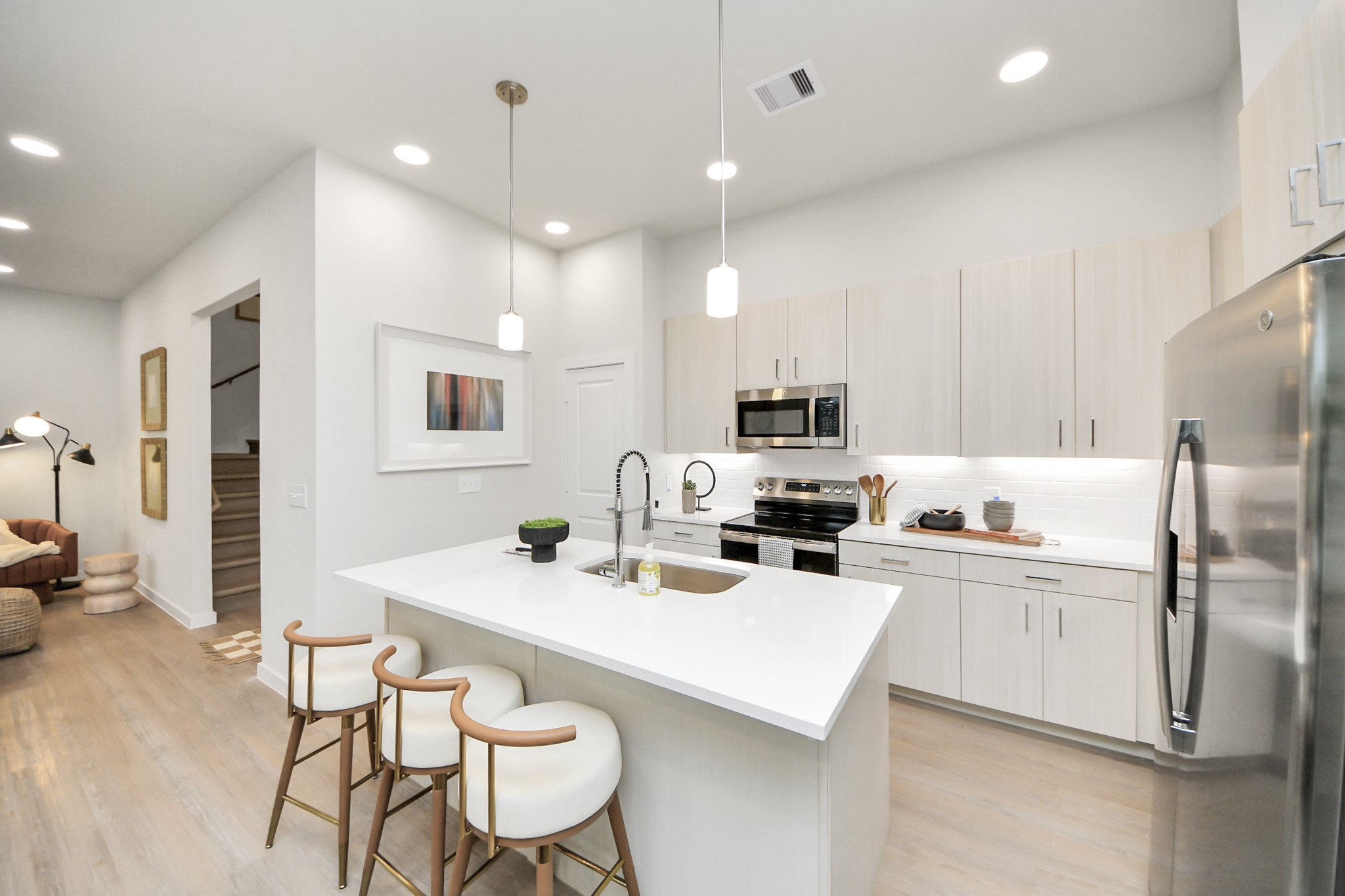 7306 Corey Rushing Lane Richmond, TX 77407 - Photo 42 of 50 a kitchen with stainless steel appliances a refrigerator a stove a sink a dining table and chairs