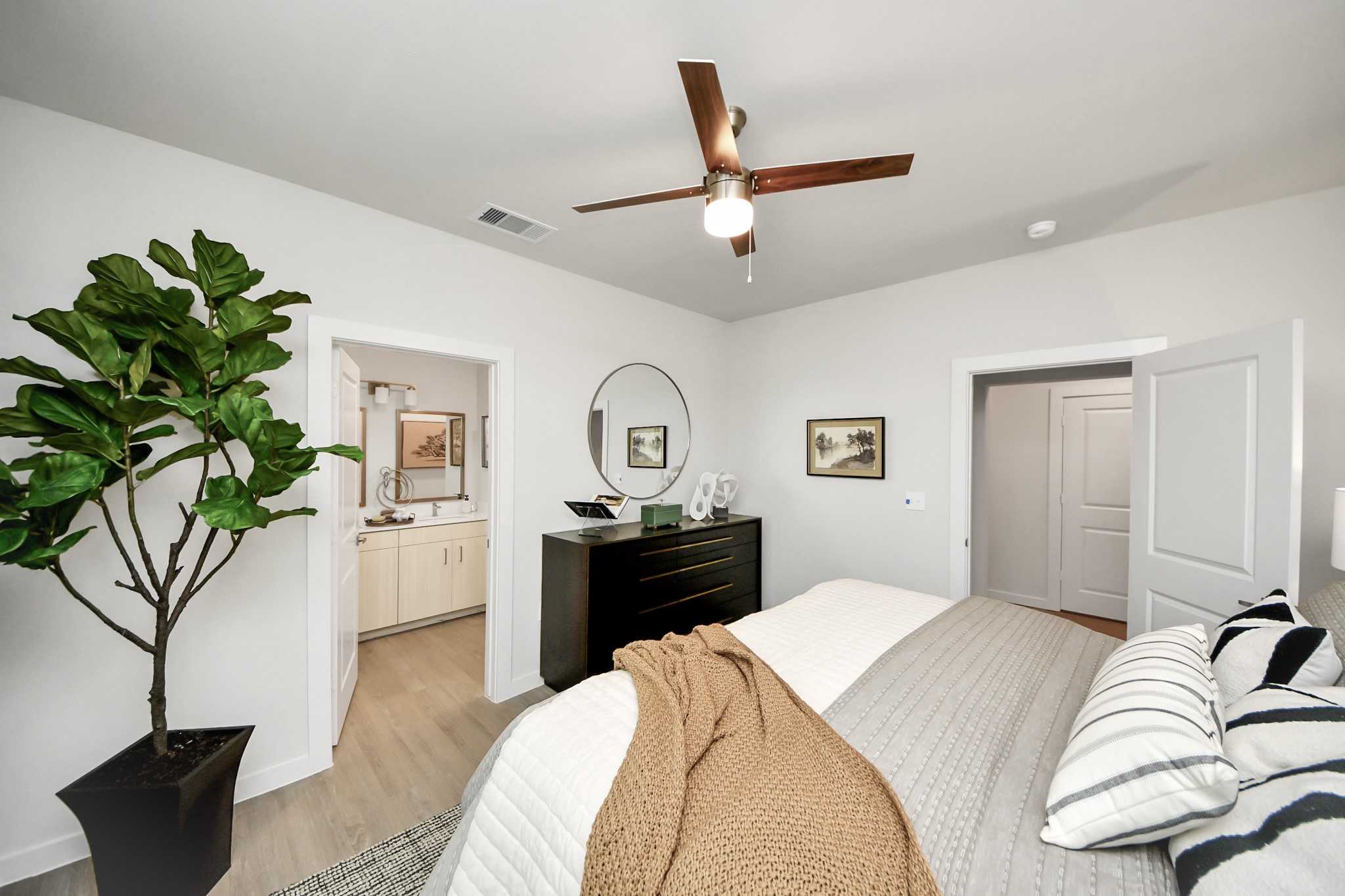 7306 Corey Rushing Lane Richmond, TX 77407 - Photo 26 of 50 a bedroom with a bed and a chandelier