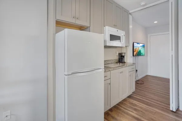 a view of a kitchen from a hallway