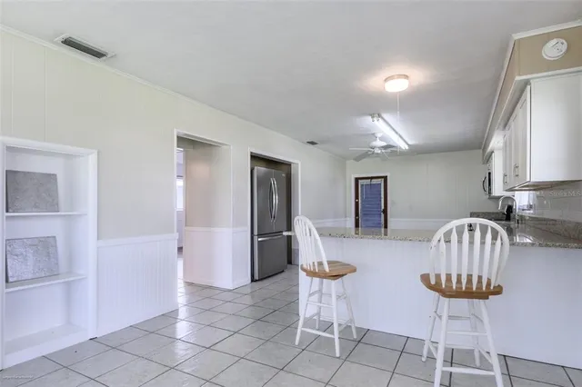 a view of kitchen cabinets and refrigerator