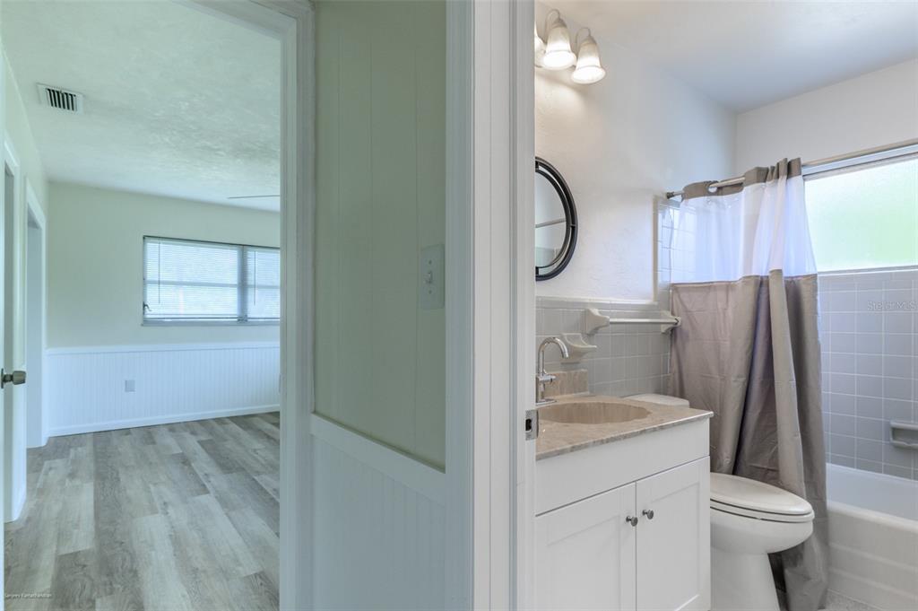 1214 Ansin Street Punta Gorda, FL 33950 - Photo 13 of 24 a bathroom with a granite countertop sink toilet and shower