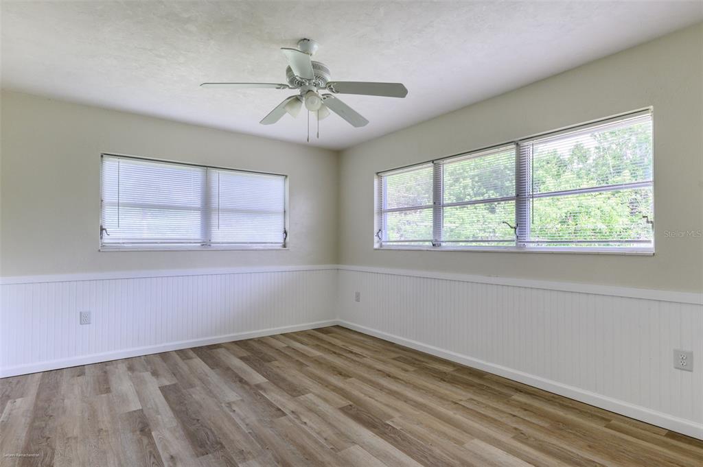 1214 Ansin Street Punta Gorda, FL 33950 - Photo 14 of 24 a view of empty room with wooden floor and fan