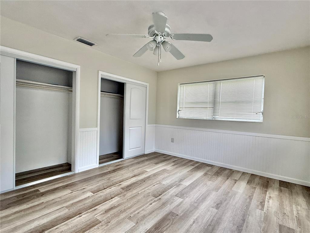 1214 Ansin Street Punta Gorda, FL 33950 - Photo 19 of 24 a view of an empty room with wooden floor and a window