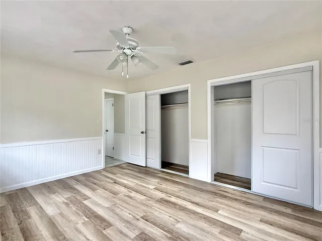 a bathroom with a granite countertop sink a toilet and a mirror