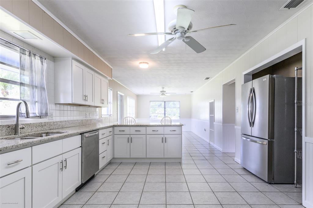1214 Ansin Street Punta Gorda, FL 33950 - Photo 4 of 24 a kitchen with a refrigerator sink and cabinets