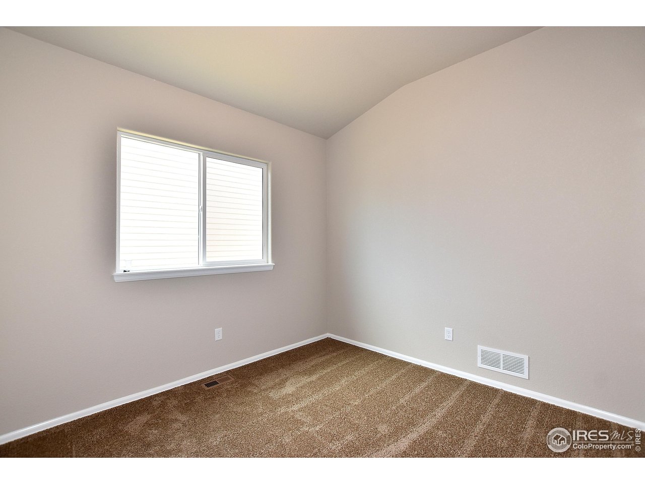 623 86th Avenue Greeley, CO 80634 - Photo 33 of 38 an empty room with wooden floor and windows