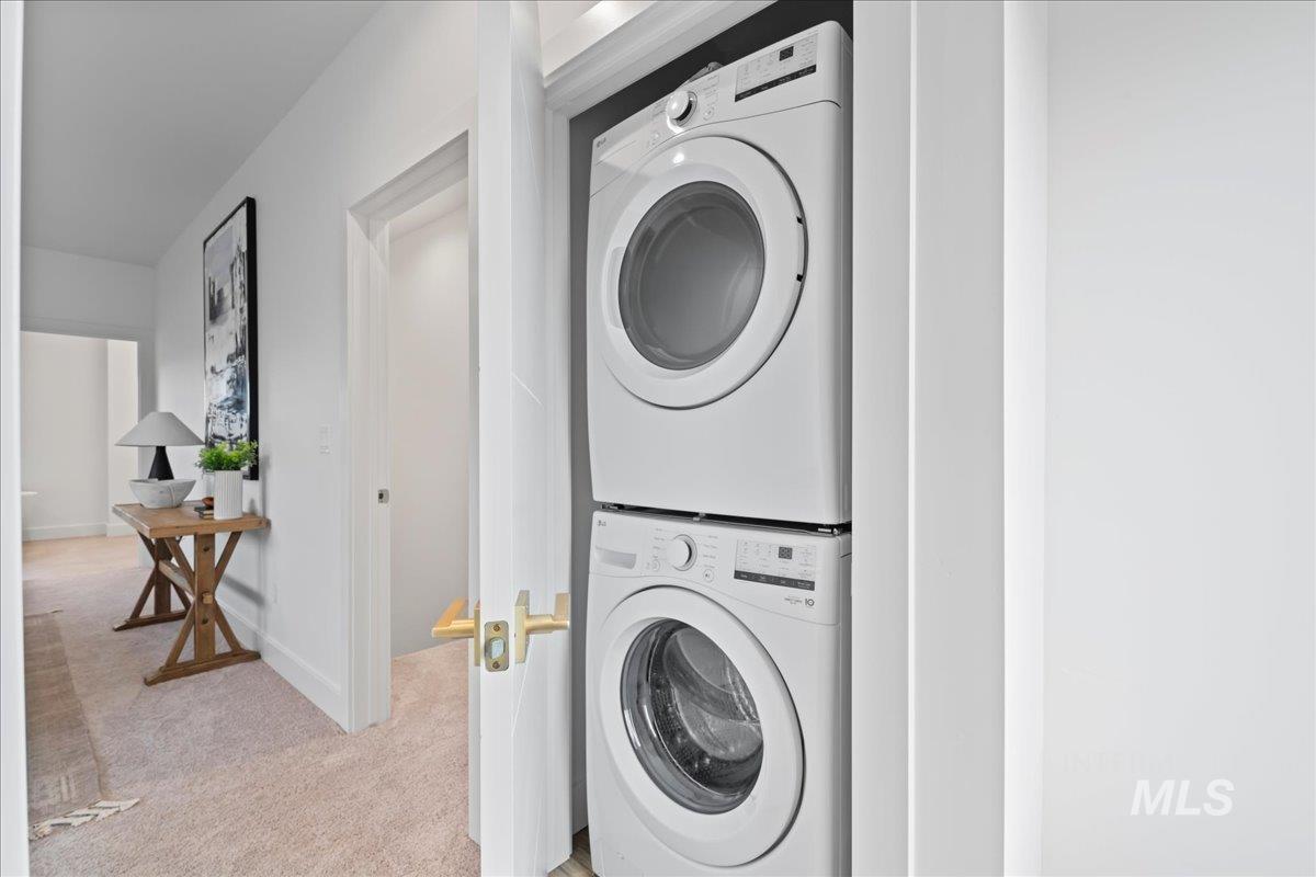 1011 South Orchard Street, Unit 101 Boise, ID 83705 - Photo 11 of 16 Laundry room featuring stacked washing machine and dryer and light colored carpet