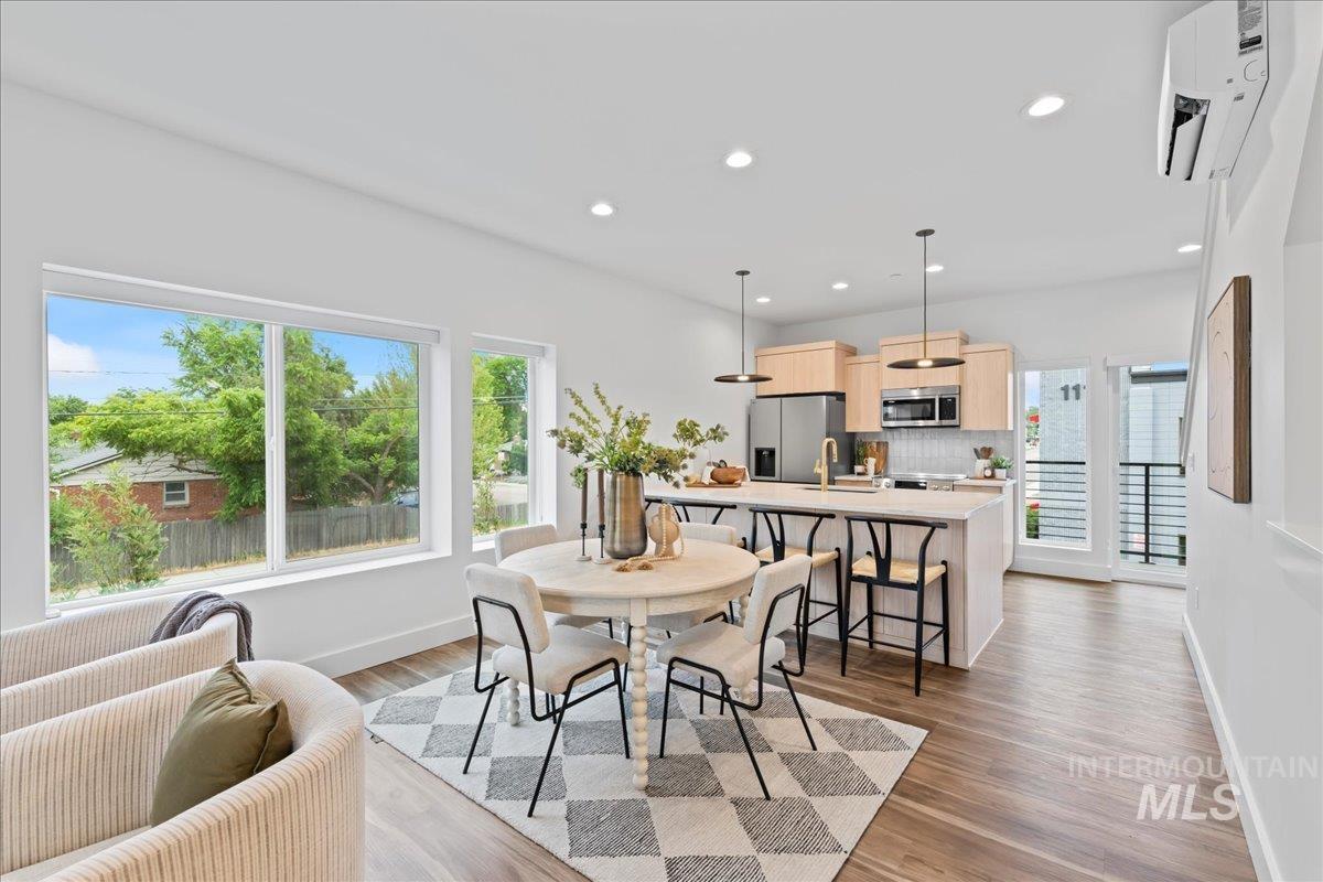 1011 South Orchard Street, Unit 101 Boise, ID 83705 - Photo 3 of 16 Showing unit 101 with light cabinet option. Dining space with recessed lighting, dark LVP floors.