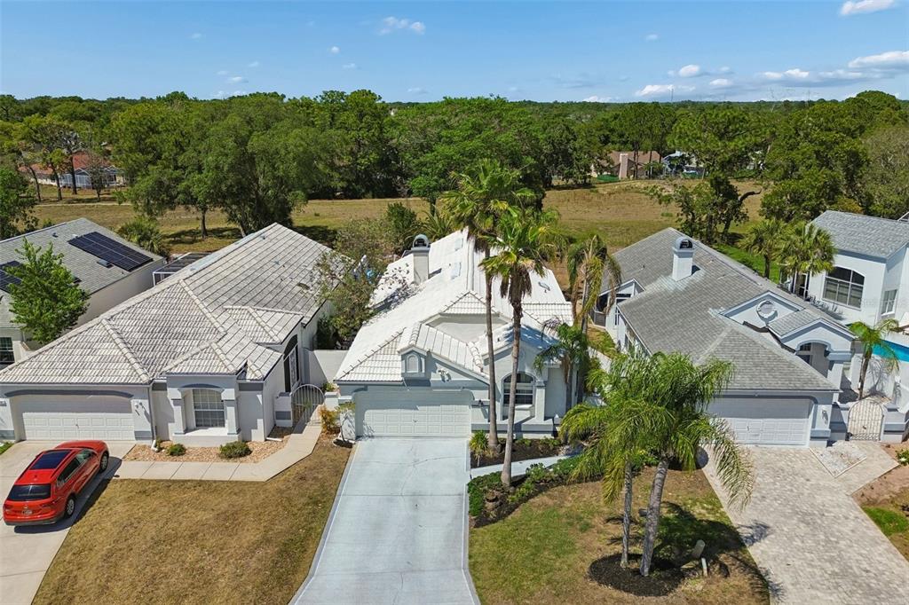10491 Casa Grande Circle Spring Hill, FL 34608 - Photo 54 of 57 an aerial view of a house with a garden and lake view