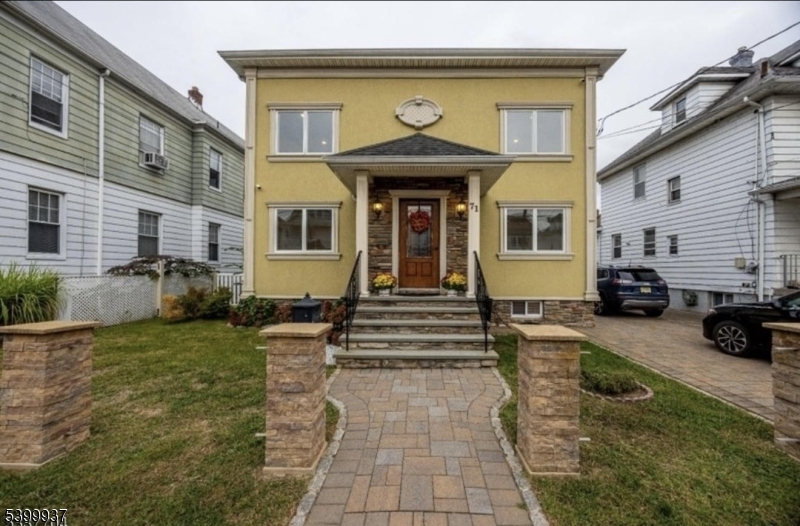 a front view of a house with garden