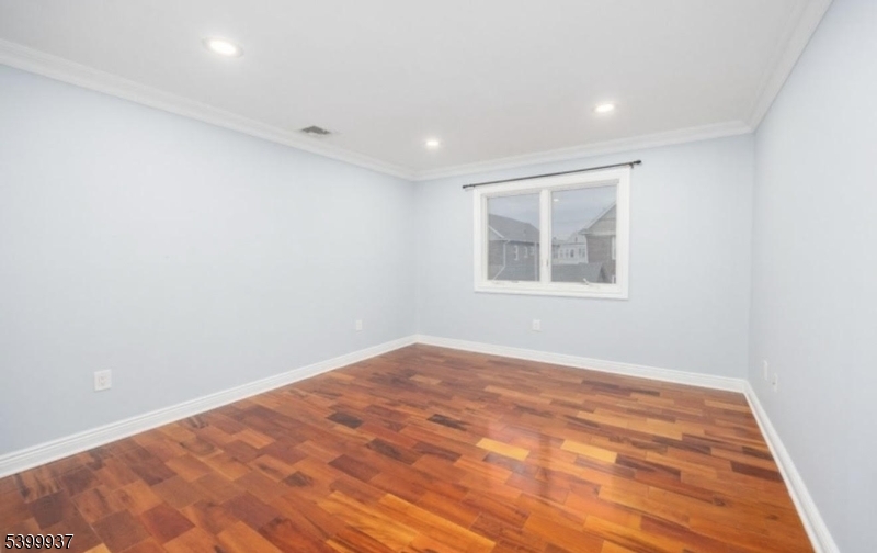 71 Christie Avenue, Unit 2 Clifton, NJ 07011 - Photo 6 of 8 an empty room with a window
