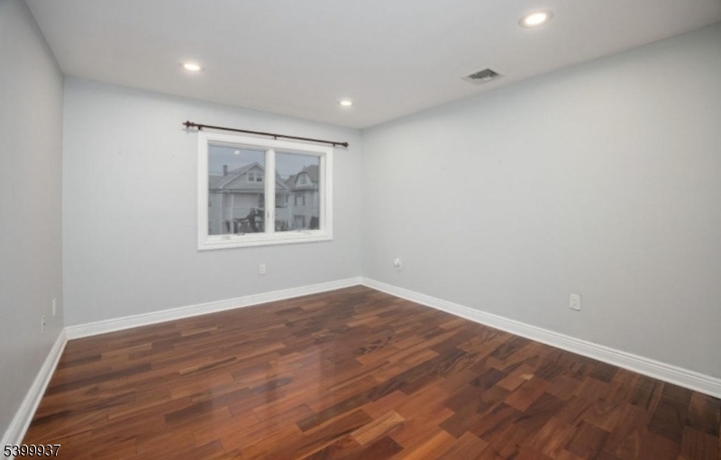 71 Christie Avenue, Unit 2 Clifton, NJ 07011 - Photo 7 of 8 wooden floor in an empty room with a window