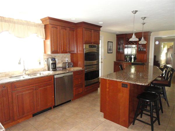 98 Bushy Lane Rutland, MA 01543 - Photo 2 of 30 a kitchen with refrigerator a sink and chairs