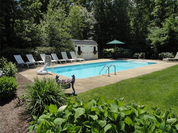 98 Bushy Lane Rutland, MA 01543 - Photo 26 of 30 a view of a swimming pool with a bench and trees