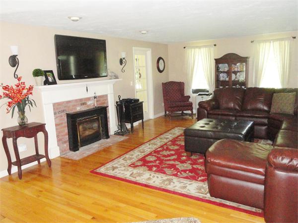 98 Bushy Lane Rutland, MA 01543 - Photo 6 of 30 a living room with furniture a flat screen tv and a fireplace