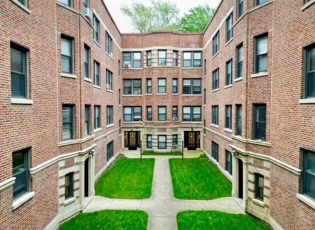 a view of an apartment with a deck and a yard