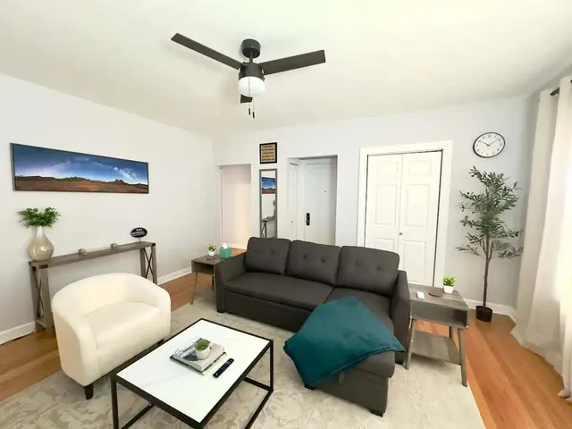 a living room with furniture and a wooden floor