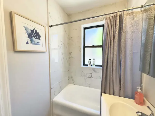 a bathroom with a bathtub and a shower
