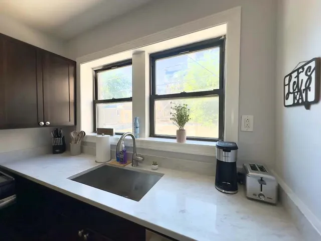 a kitchen with a sink a counter top space and a window