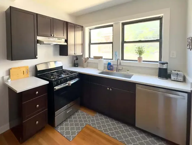 a kitchen with a sink stove and microwave