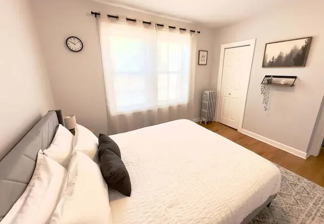 a bedroom with a bed and a window