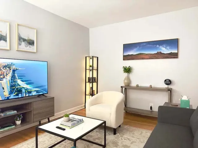 a living room with furniture and painting on the wall