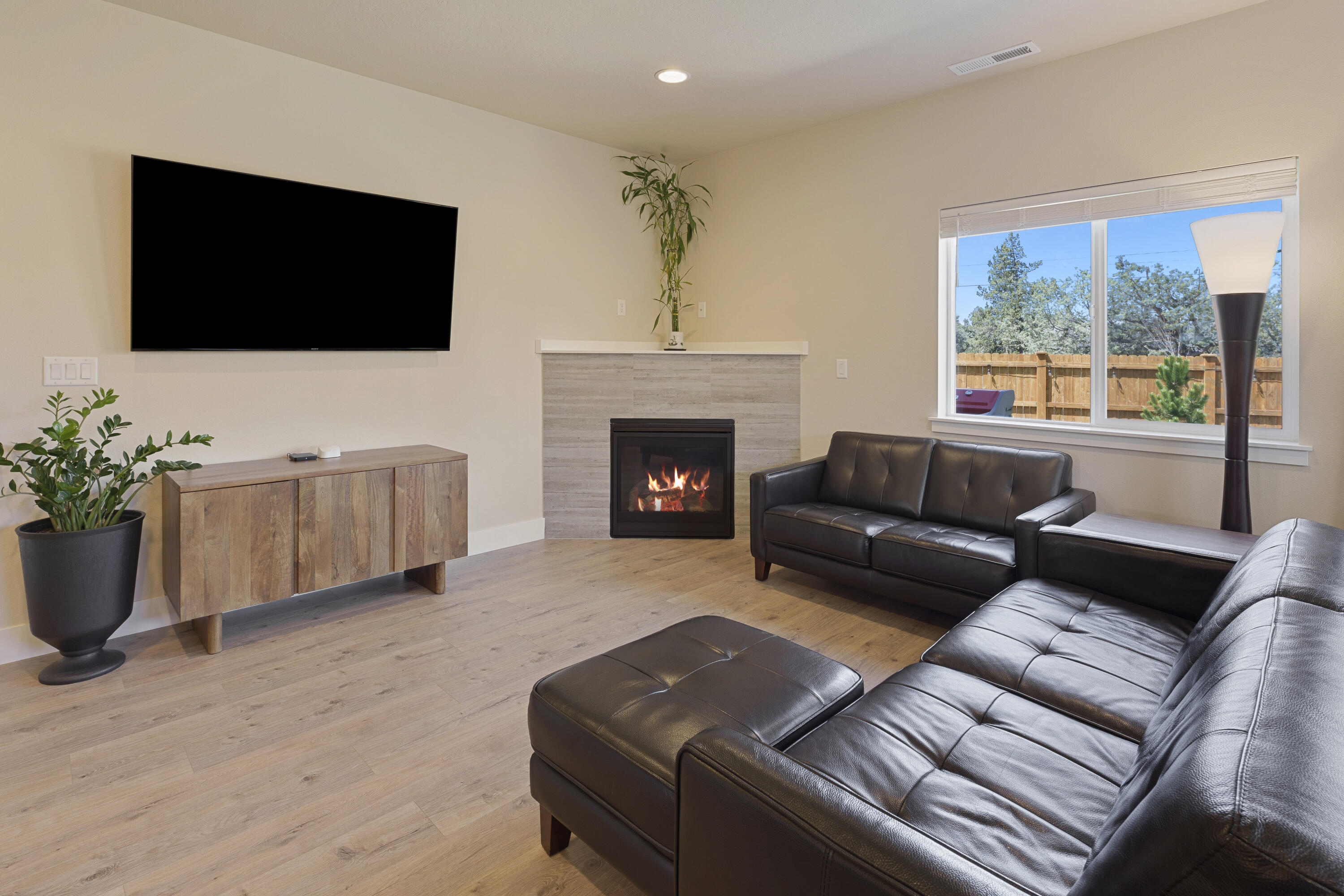 4999 Southwest Yew Place Redmond, OR 97756 - Photo 16 of 50 a living room with furniture a fireplace and a flat screen tv